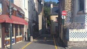 A street view with a hotel on the left and a building with a sign on the right.