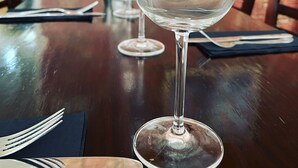 A dining table with a wine glass, cutlery, and a napkin. - The Grand Harbour Hotel (Ilfracombe)