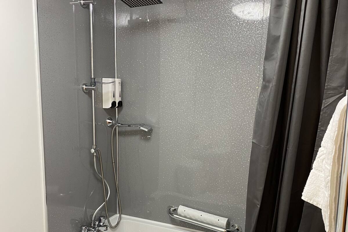 Ein modernes Badezimmer mit Dusche, Toilette und Badewanne.