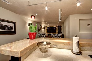 Bathroom features a sleek design with a large mirror and a bathtub.