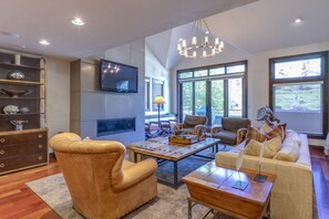 Relax in a cozy living room with a comfortable seating area, leather armchair, and sofa, perfect for unwinding.