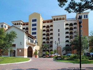 Stunning hotel with a classic facade, featuring a central courtyard and beautifully landscaped grounds.