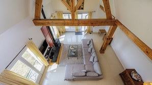 A spacious living room with a large sectional sofa, a coffee table, and a fireplace. - Mirandole, modern holiday home with views and heated pool (Martel)