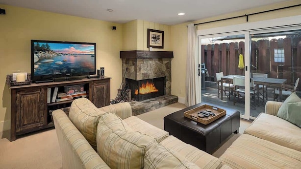 A living room with a fireplace, a television, and a sofa. - Steps from Beach-N-Mins to SKI - Updated Interior (Tahoe Vista)