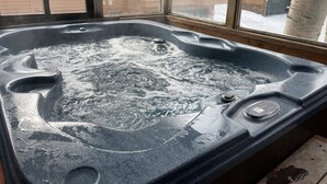 A hot tub with a control panel, visible through a window. - True ski in-ski out, walk to slopes & town, private hot tub, brand new kitchen (Breckenridge)