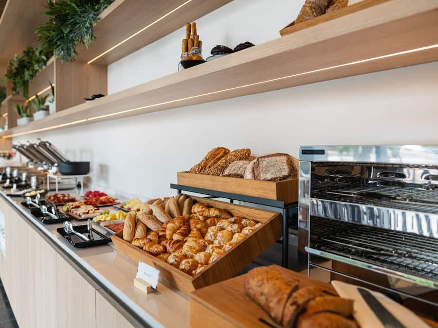 A buffet with various baked goods and pastries.
