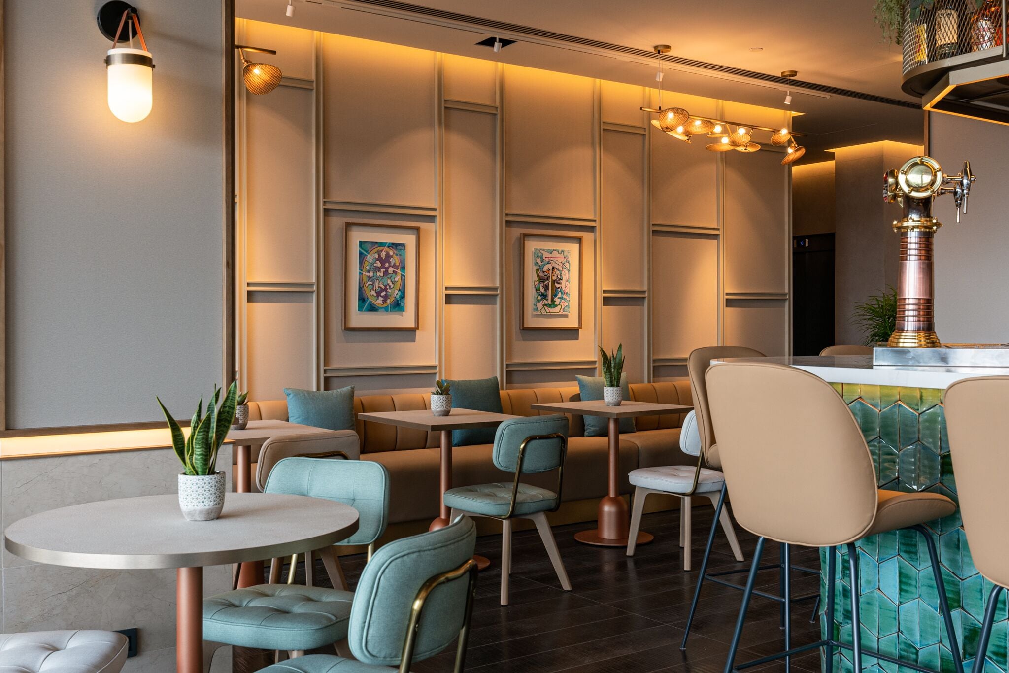 A modern interior with seating areas, tables, and decorative lighting.