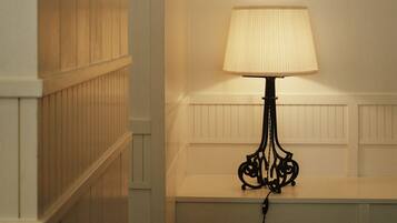 A room with a wooden cabinet and a table lamp.