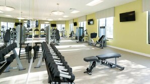 A gym with various exercise equipment, including dumbbells, treadmills, and weight machines. - Resort acess - Last minute deal (Kissimmee)