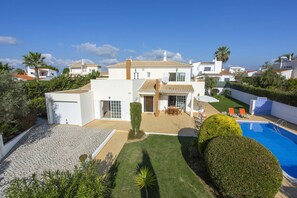 A modern villa with a swimming pool, a patio with outdoor furniture, and a well-maintained garden. - Villa Concorde by Villa Plus (Carvoeiro)