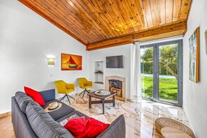 Relax in this stylish living room with a fireplace, flat-screen TV, and comfortable seating area.