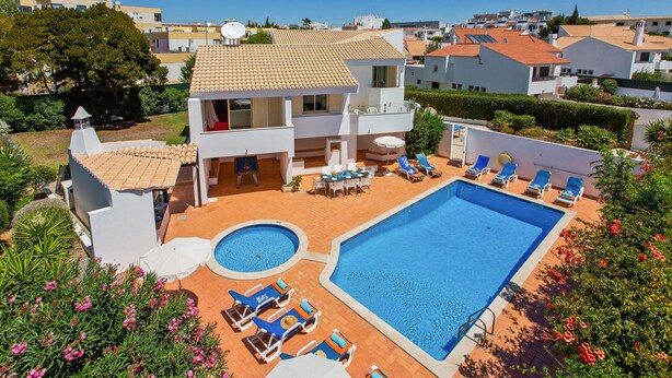 A two-story house with a swimming pool, outdoor seating, and a garden. - Villa Papi by Villa Plus (Albufeira)