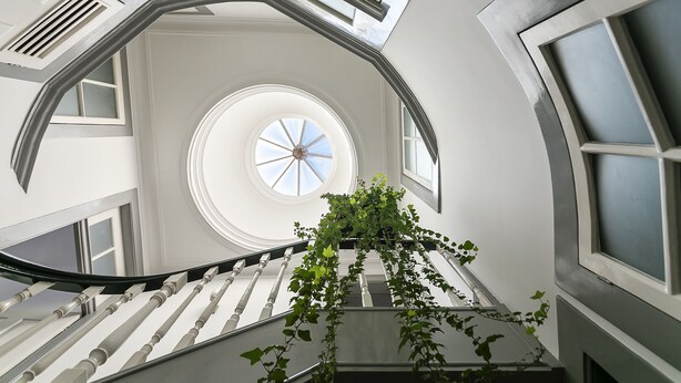 A spiral staircase with a skylight and a view of the sky.