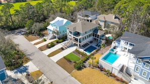 A large, multi-story residential property with a swimming pool, multiple decks, and a well-maintained lawn. - 1 Shore Crest, Large Pool, Ping Pong, Beach, Free Golf, Outdoor Kitchen (Hilton Head)