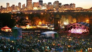 A large outdoor concert with a city skyline in the background. - Contemporary Oasis in the Heart of Old Strathcona (Edmonton)