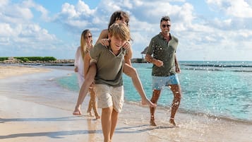 On the beach, white sand, sun loungers, beach towels