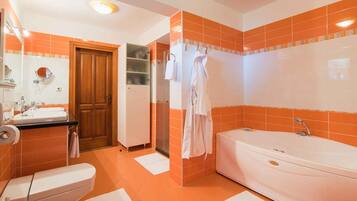 A bathroom with a toilet, sink, and bathtub.