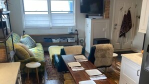 Une cuisine moderne avec une table à manger en bois, des tabourets de bar et un four encastré.