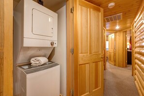 Washer and dryer located next to bedrooms.