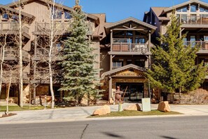 A lodge with a prominent entrance, multiple balconies, and a rustic architectural style.