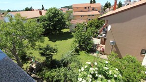 A residential area with a courtyard surrounded by buildings with red-tiled roofs.