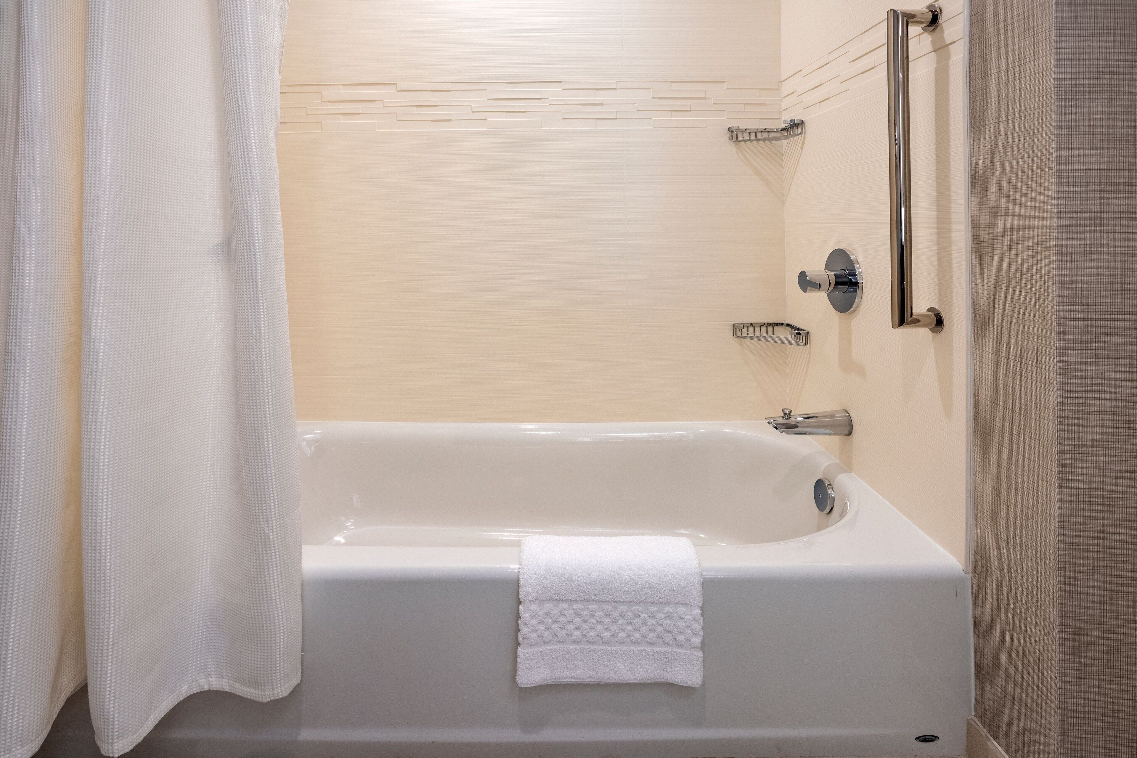 A bathroom with a bathtub, a shower, and a toilet.