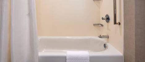 A bathroom with a bathtub, a shower, and a toilet.