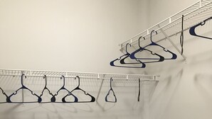 A laundry room with multiple drying racks and a door. - One Bedroom Peachtree Atlanta GA (Dunwoody)