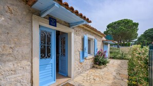 A stone building with blue doors and shutters, a sign reading "KUČA ZA ODMOŘ", and a stone pathway leading to the entrance. - 2 bedroom beach front home in Vabriga (Vabriga)