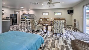 A hotel room with a kitchenette, a sofa set, a bed, and a TV. - Detached Watauga Riverfront Studio w/ Grill (Elizabethton)