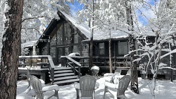 Escape to a serene winter wonderland amidst snow-covered trees and a cozy cabin.
