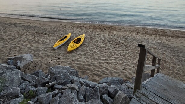 A beach with kayaks and a wooden boardwalk. - Private beach location (Oscoda)