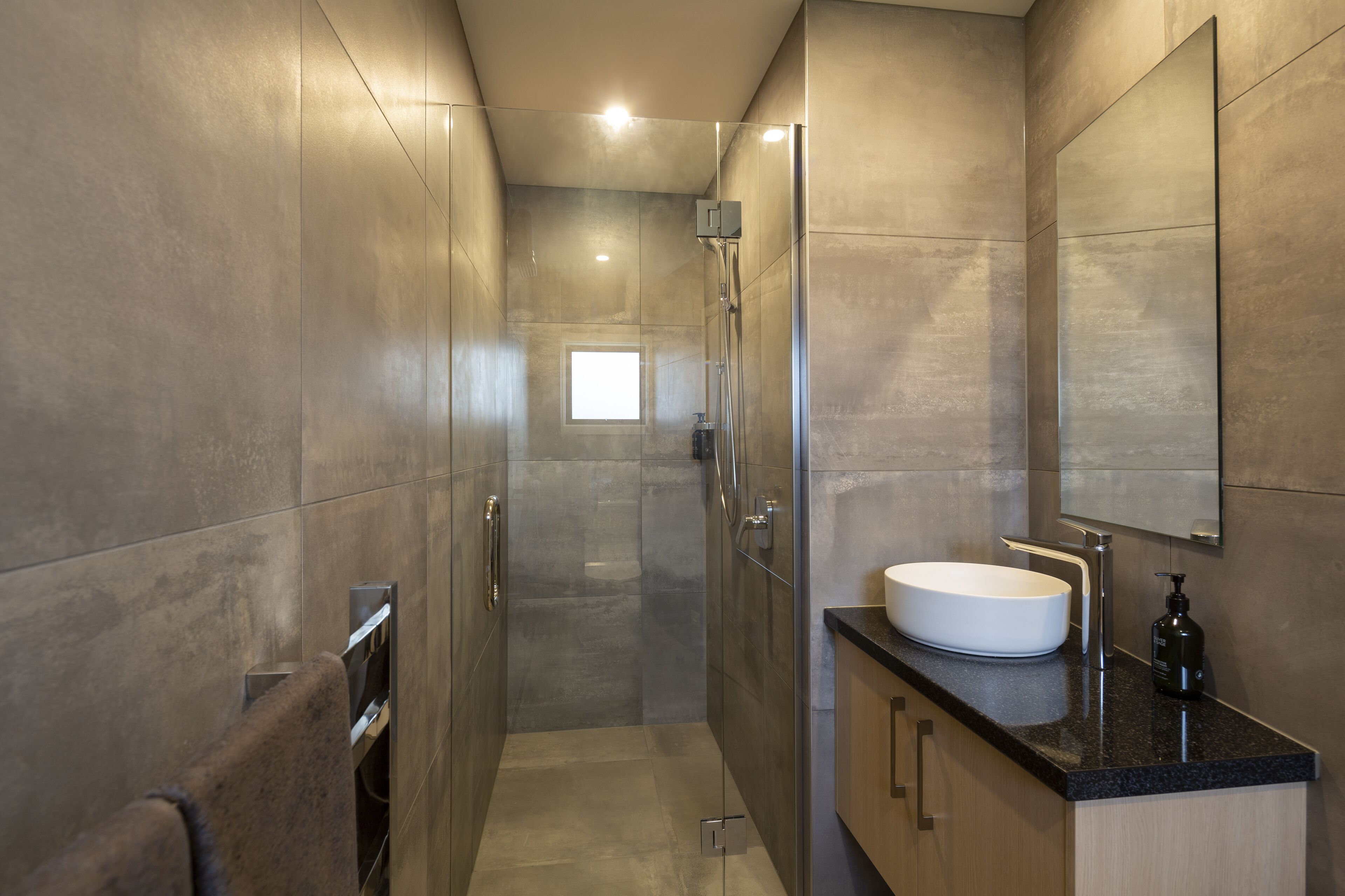 Shower, designer toiletries, hair dryer, towels