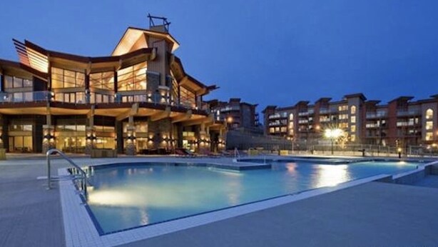 A modern hotel with a large pool area and multiple balconies. - Pools open May long weekend!  Holiday Time @ West Kelowna's hidden gem!  2BR (West Kelowna)