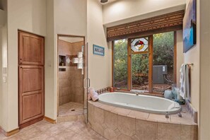 Bathtub, hair dryer, towels, shampoo