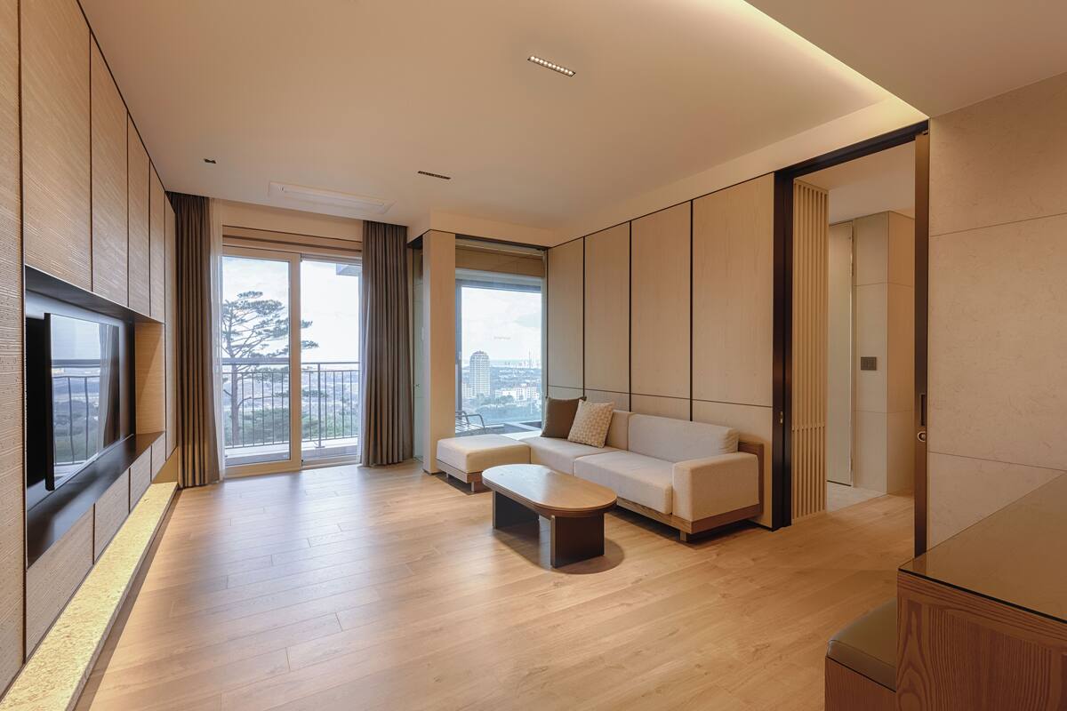 A modern living room with a sofa, a coffee table, and a TV.