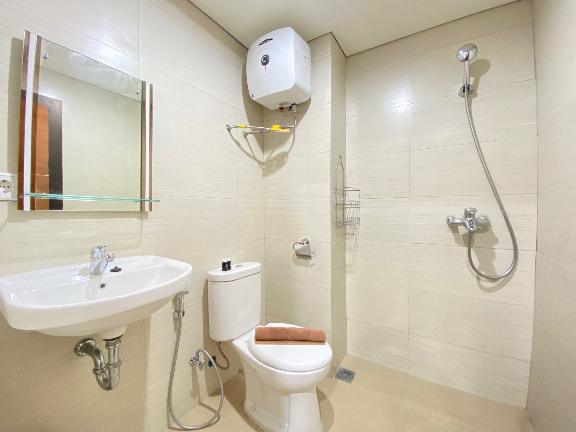 A bathroom with a sink, toilet, and shower.