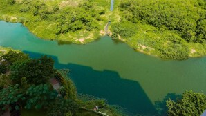 An aerial view of a river with dense greenery on both sides. - Relaxing Studio at Springlake Summarecon Bekasi Apartment (Bekasi)