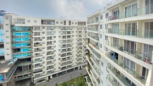 A multi-story residential building with balconies, large windows, and a clear sky. - Luxurious & Cozy 2BR Gateway Pasteur Apartment near Exit Toll (Cimahi)