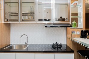 Room | Private kitchen | Fridge, stovetop, cookware/dishes/utensils - Minimalist and Cozy Studio Apartment at Tuscany Residences (South Tangerang)