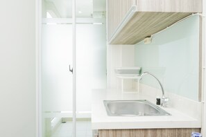 Enjoy cooking in this well-equipped kitchen with a stainless steel sink, modern faucet, and ample countertop space.