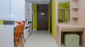 A hallway with a desk, chairs, a door, and a mirror. - Fully Furnished with Comfortable Design Studio Apartment H Residence (Jakarta)