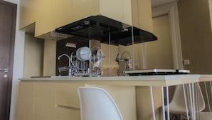 A modern kitchen with a dishwasher, a stove, and a sink.