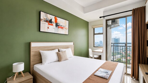 A modern hotel room with a large bed, a desk, and a city view. - Bright Studio Apartment at Springwood Residence (Tangerang)