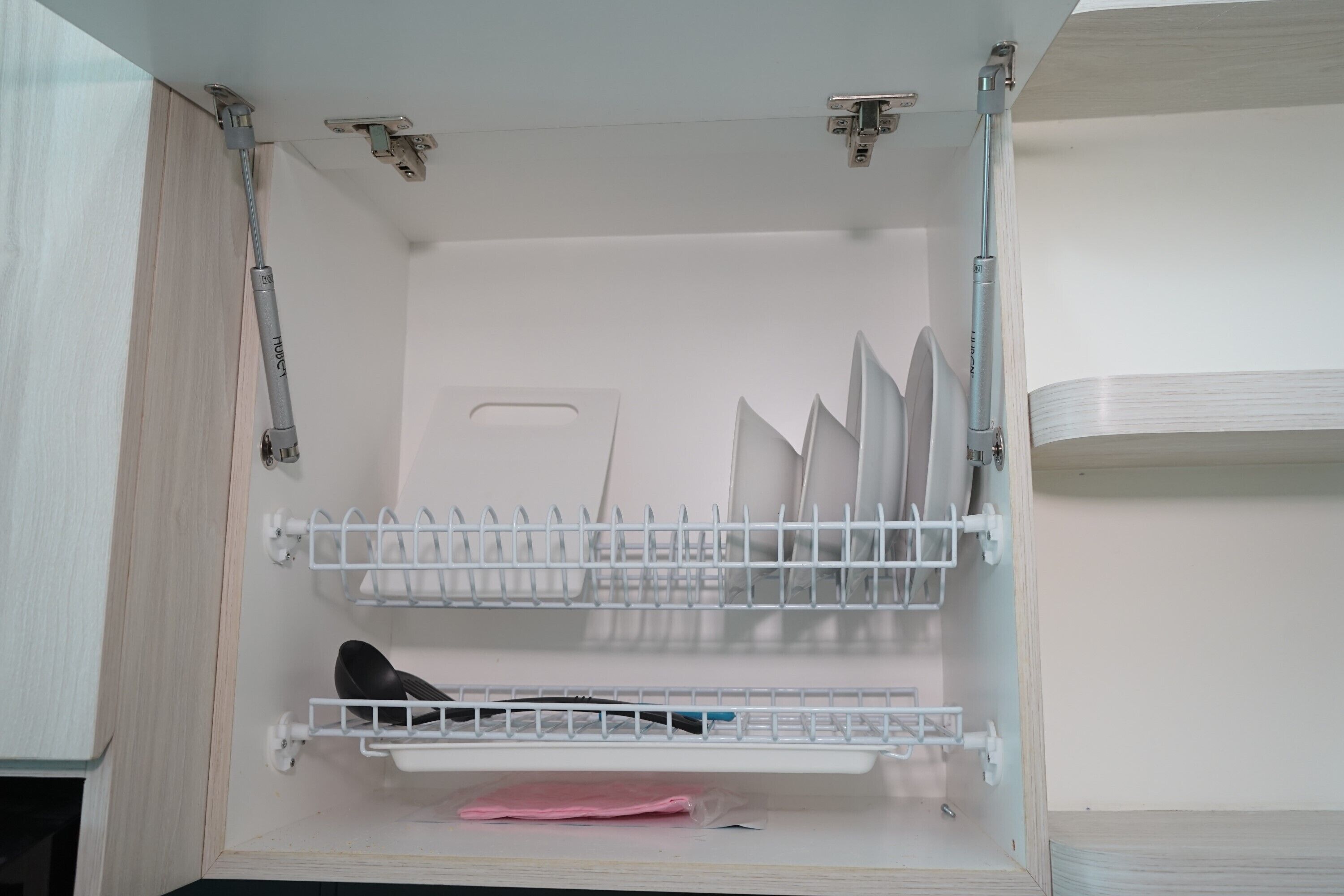 A storage cabinet with multiple shelves, a door, and a metal rod.