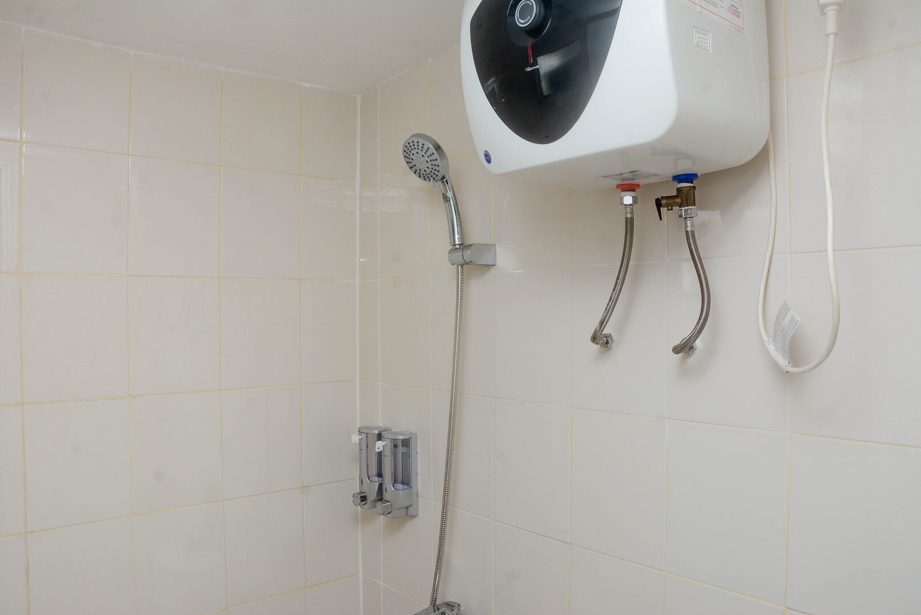 A bathroom with a shower, a toilet, and a sink.