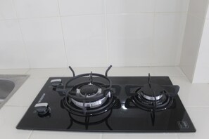 A black gas stove with four burners and a control panel.