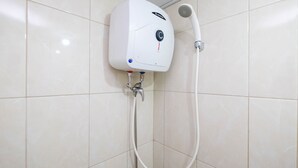 A wall-mounted shower unit with a control panel and a handheld showerhead. - Comfortable Studio at Springlake Summarecon Bekasi Apartment (Bekasi)