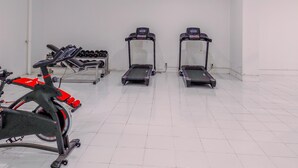 A gym with treadmills, a stationary bike, and dumbbells. - Cozy and Simply Studio Apartment at Urban Heights Residences (South Tangerang)