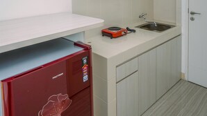 Room | Private kitchen | Fridge, stovetop, cookware/dishes/utensils - Cozy and Simply Studio Apartment at Urban Heights Residences (South Tangerang)